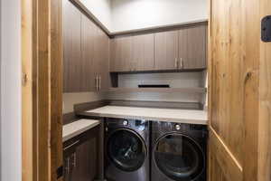 Laundry room with cabinet space and washer and dryer