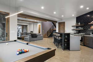 Playroom with billiards, finished concrete flooring, beamed ceiling, and recessed lighting