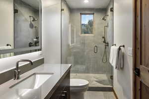 Full bath with a shower stall and vanity