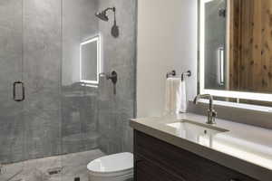 Full bath with vanity and a shower stall