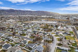 Aerial overview of property's location featuring nearby suburban area and a mountainous background