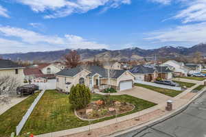 Traditional home with concrete driveway, a residential view, and a mountain view