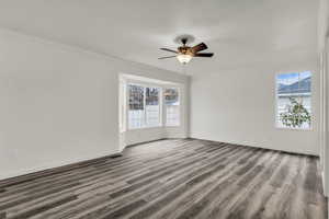 Unfurnished room with ornamental molding, light wood finished floors, and a ceiling fan