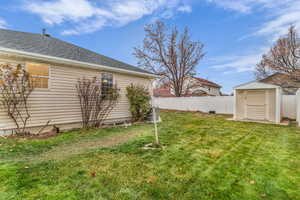 Fenced backyard with a storage shed