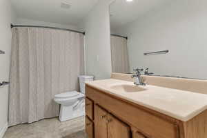 Bathroom with vanity and curtained shower