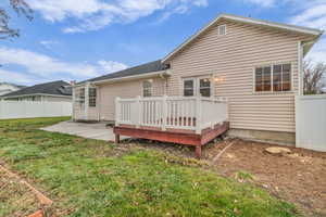 Back of house featuring a deck and a patio