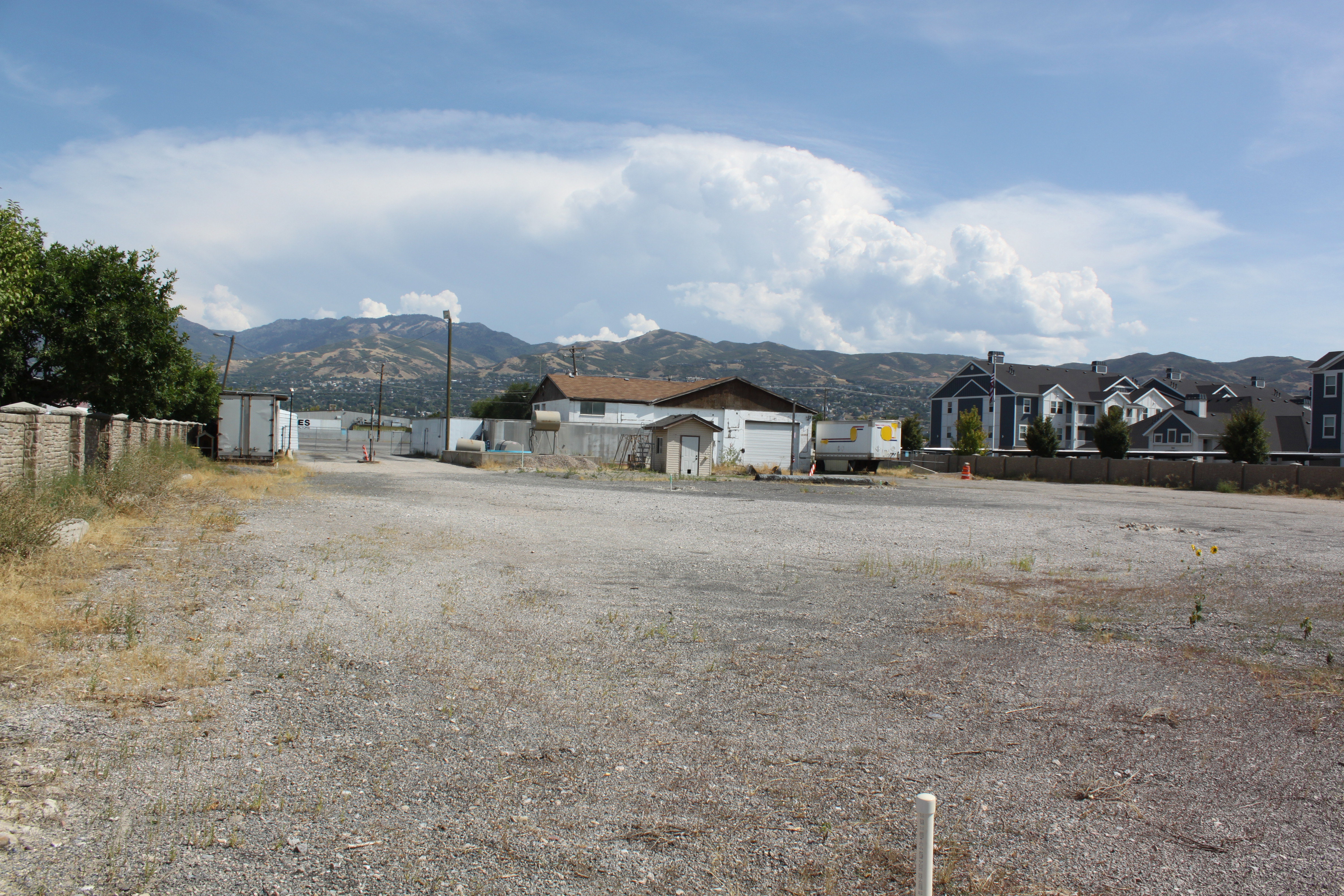 View of front of home featuring a mountain view, a residential view, and an outbuilding