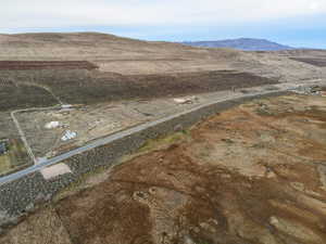 Aerial overview of property's location featuring a mountain backdrop and rural landscape