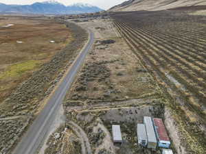 Aerial view of property's location featuring rural landscape, rows of crops, and a mountain backdrop