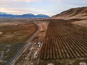 Aerial view of sparsely populated area with a mountainous background and extensive farmland