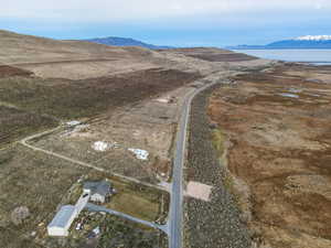 Aerial view of property and surrounding area with a mountainous background and rural landscape