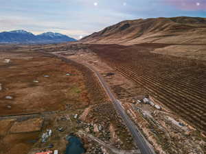 Aerial overview of property's location featuring rural landscape and a mountainous background