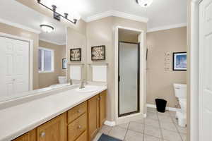 En suite  bath featuring crown molding,
