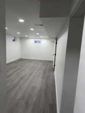 Basement with wood finished floors and recessed lighting