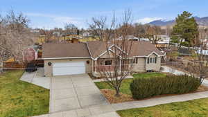 Single story home with concrete driveway, an attached garage, roof with shingles, a chimney, and a residential view