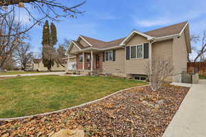 Single story home featuring covered porch, concrete driveway, and roof with shingles