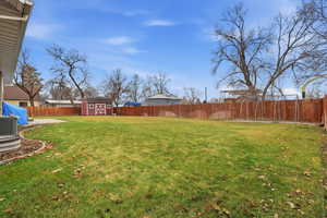 Fenced backyard with a shed