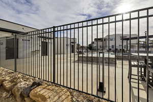 Gate featuring a community pool and a patio