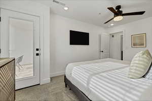 Bedroom with light colored carpet, a ceiling fan, and recessed lighting