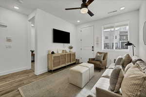 Living area with wood finished floors, recessed lighting, and ceiling fan