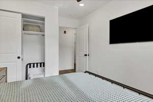 Bedroom with a closet, recessed lighting, and a ceiling fan