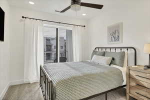 Bedroom featuring access to exterior, light carpet, ceiling fan, and recessed lighting