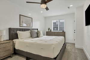 Bedroom featuring light carpet, a ceiling fan, and recessed lighting