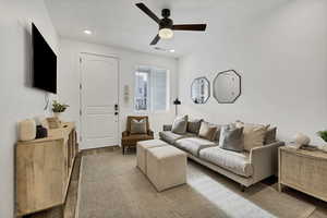 Living area with wood finished floors, ceiling fan, and recessed lighting
