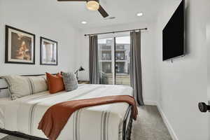 Bedroom with light carpet, a ceiling fan, and recessed lighting