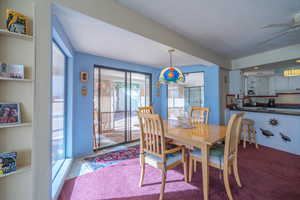 Dining space with carpet and a ceiling fan