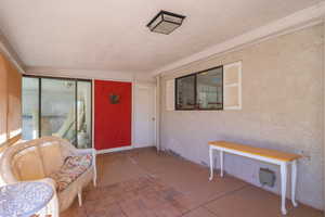 Doorway to Storage Area  with a patio area and stucco siding