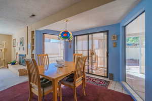 Dining room featuring a textured ceiling and tile patterned floors