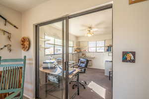Carpeted office space with plenty of natural light and a ceiling fan off of Primary Bedroom /Game Room