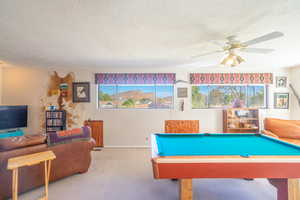 Primary bedoom  used as game room with VIEWS, carpet flooring, billiards table, a textured ceiling, and a ceiling fan