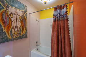 Primary Bathroom featuring shower / bath combination with curtain