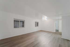 Unfurnished room with light wood-style flooring and baseboards