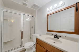 Bathroom featuring a stall shower and vanity