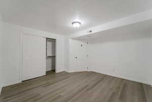 Unfurnished bedroom with light wood-type flooring and a closet