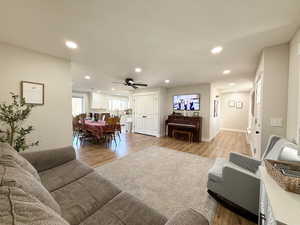 Living area featuring light wood finished floors, recessed lighting, and ceiling fan