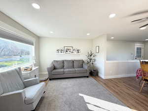 Living room with wood finished floors, recessed lighting, and ceiling fan