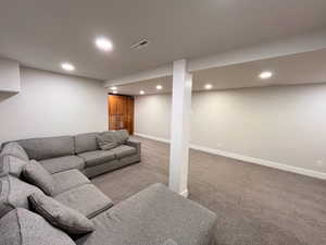Living room with light carpet and recessed lighting