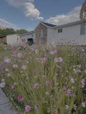 View of front of property featuring stone siding and board and batten siding