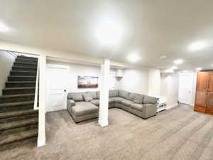 Living room with light carpet and stairs