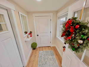 Entryway featuring wood finished floors and baseboards