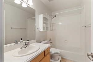Bathroom featuring vanity, tub / shower combination, and light tile patterned floors