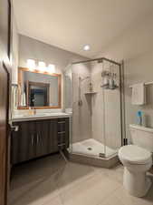 Bathroom featuring vanity, a stall shower, light tile patterned floors, and a textured ceiling