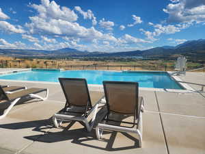 View of swimming pool featuring a mountain view and a patio