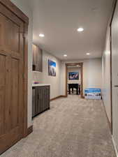 Below grade area featuring light colored carpet and recessed lighting