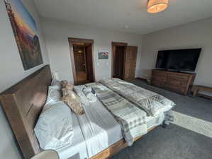 Bedroom with carpet floors and ensuite bathroom