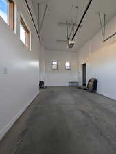 Garage with baseboards and a garage door opener